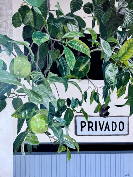 View of a garage sign through tree leaves