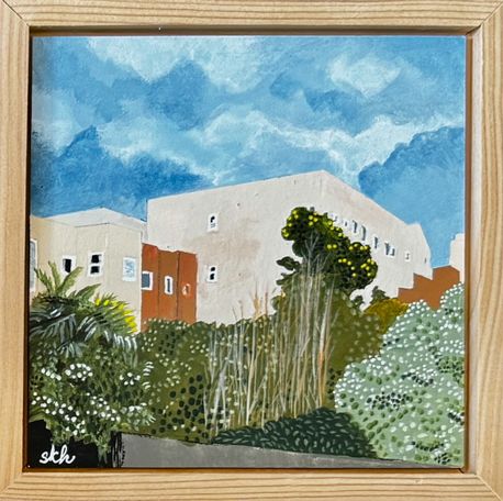 Small view of beige buildings and greenery