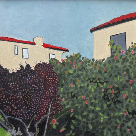 Two Mediterranean-style homes behind shrubbery